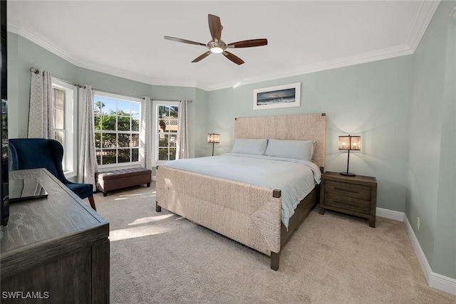 bedroom with ceiling fan, light colored carpet, and crown molding