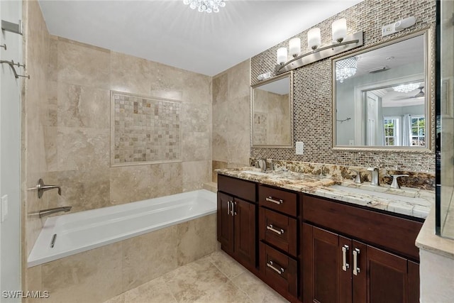 bathroom featuring vanity, tiled bath, and tile walls