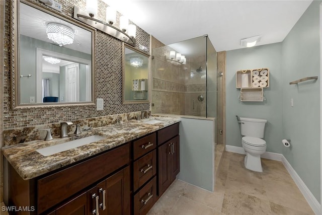 bathroom with decorative backsplash, vanity, an enclosed shower, and toilet