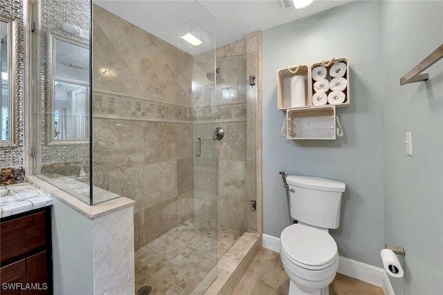 bathroom featuring tile patterned floors, vanity, toilet, and a shower with door