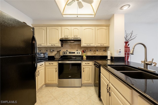 kitchen with tasteful backsplash, dark stone countertops, under cabinet range hood, black appliances, and a sink