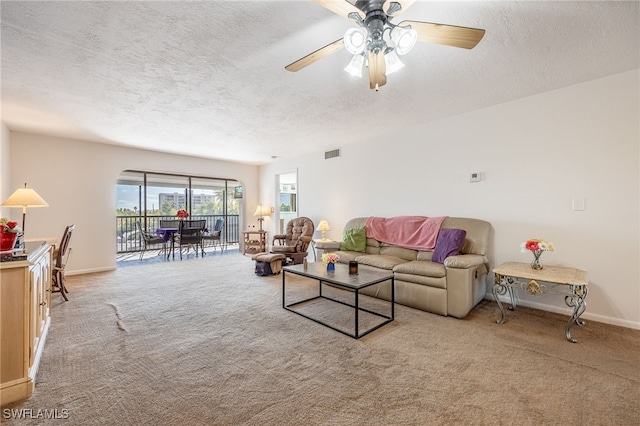 living room featuring baseboards, visible vents, and light colored carpet