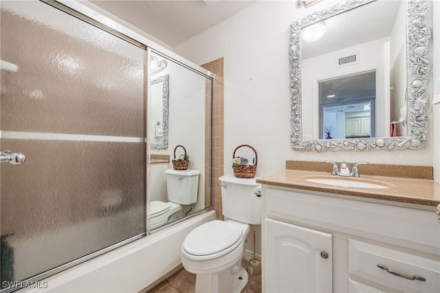 full bathroom featuring visible vents, shower / bath combination with glass door, vanity, and toilet