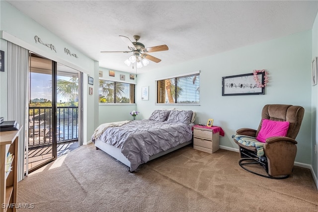 carpeted bedroom with access to outside, ceiling fan, a textured ceiling, and baseboards