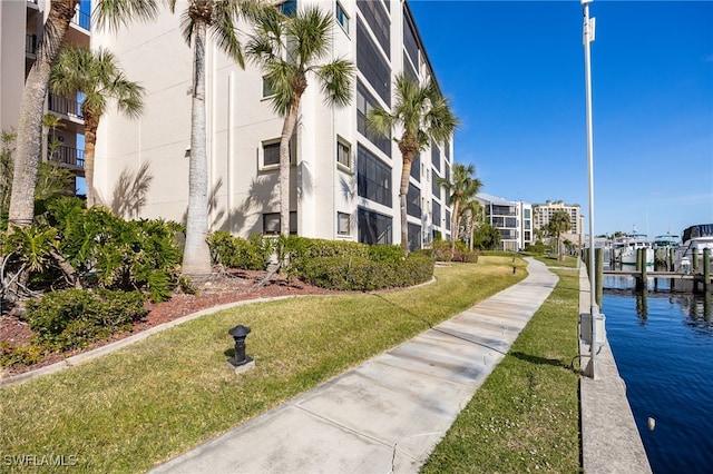 view of property's community featuring a water view and a lawn