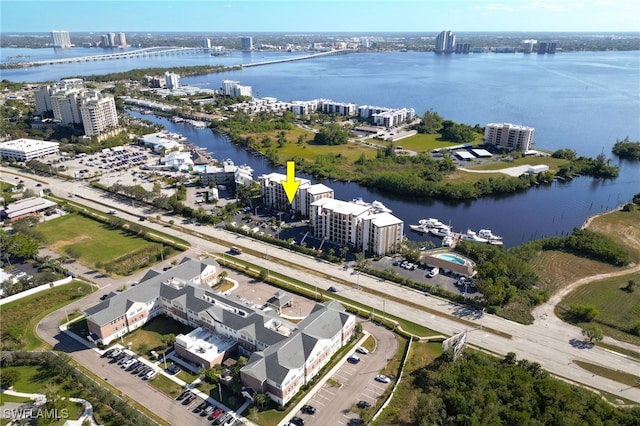 birds eye view of property featuring a water view and a view of city