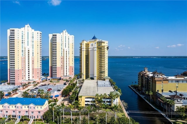 birds eye view of property with a water view and a view of city