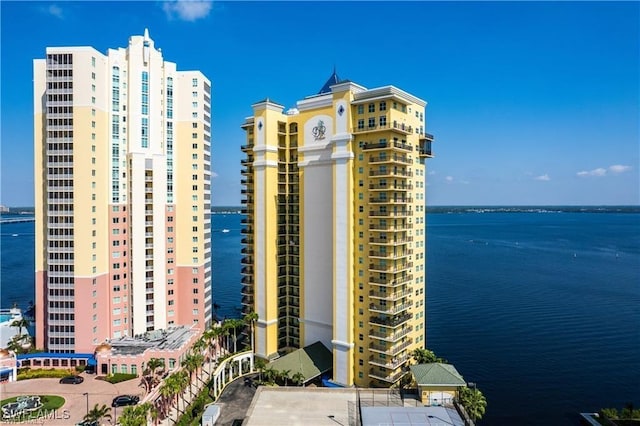 view of building exterior with a water view and a city view