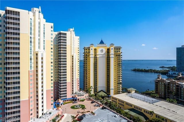 view of building exterior featuring a water view and a view of city