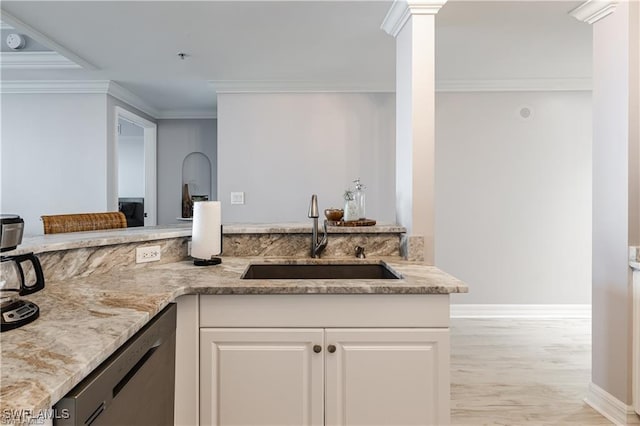 kitchen with light wood-type flooring, ornamental molding, stainless steel dishwasher, a sink, and light stone countertops