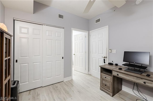 home office with baseboards, ceiling fan, visible vents, and light wood finished floors