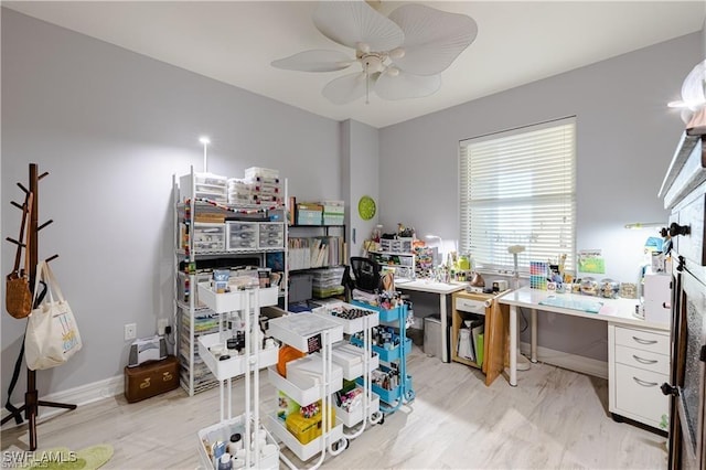 home office with ceiling fan and light wood-type flooring