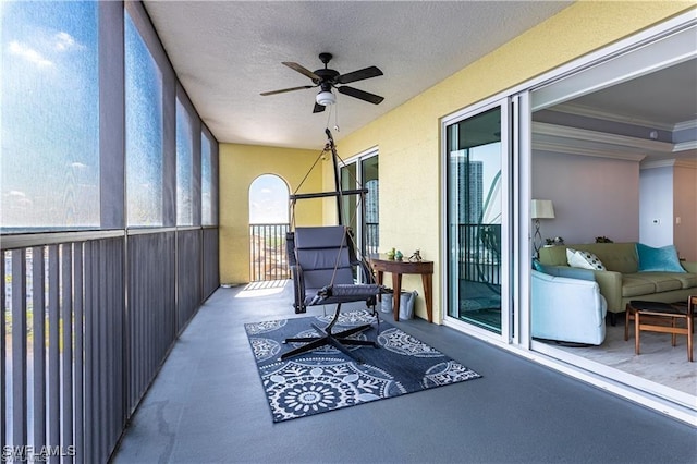 sunroom / solarium featuring ceiling fan