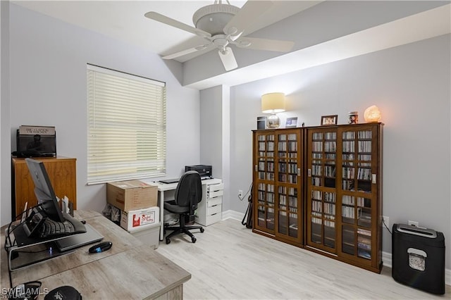 office area with a ceiling fan, baseboards, and wood finished floors