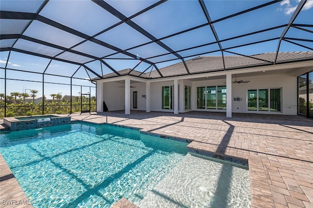 view of swimming pool with a patio, ceiling fan, an in ground hot tub, and glass enclosure