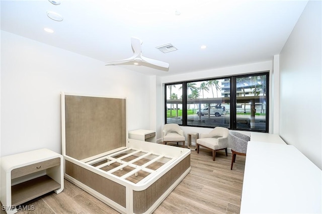 bedroom with light hardwood / wood-style floors and ceiling fan