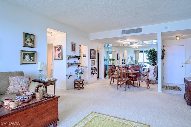 carpeted living room featuring a textured ceiling