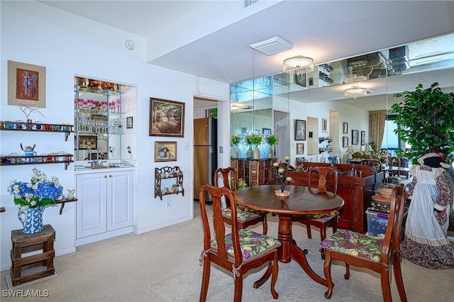 carpeted dining area with sink