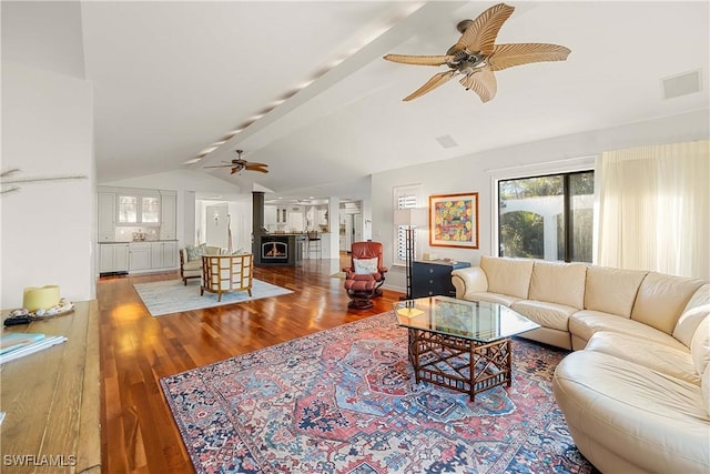 living room with vaulted ceiling with beams, ceiling fan, and hardwood / wood-style flooring