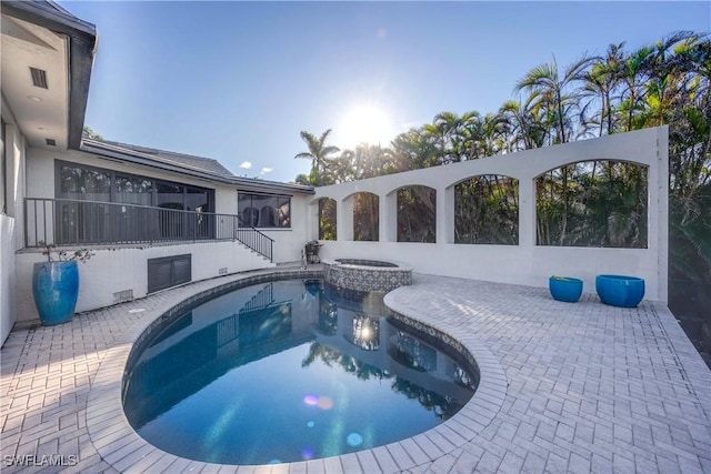 view of pool featuring an in ground hot tub and a patio