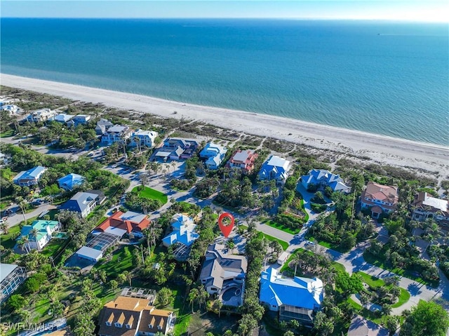 birds eye view of property featuring a beach view and a water view