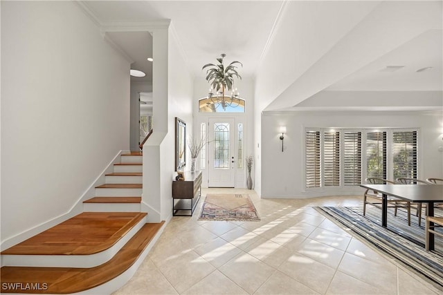 tiled foyer entrance with a notable chandelier