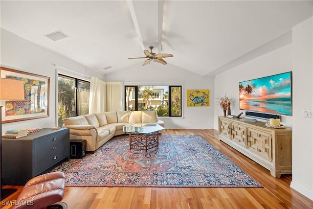 living room with ceiling fan, hardwood / wood-style floors, and lofted ceiling