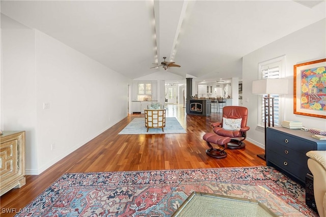 living room with hardwood / wood-style floors, lofted ceiling with beams, and ceiling fan