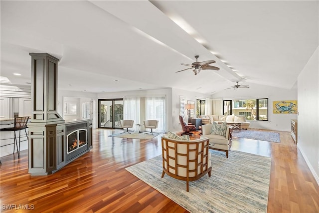 living room with hardwood / wood-style floors, ceiling fan, and a healthy amount of sunlight