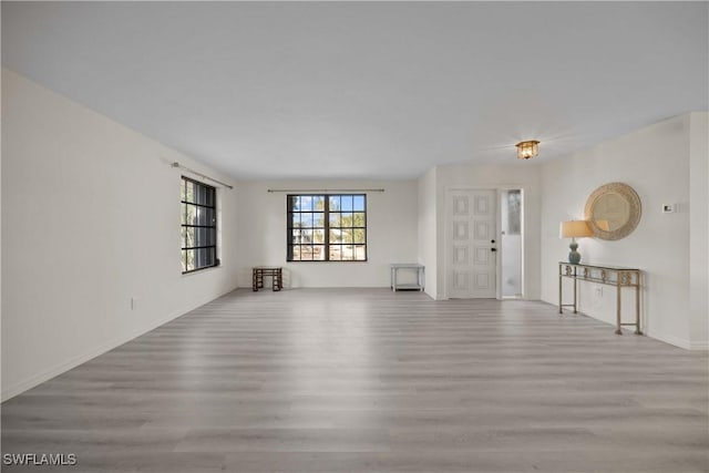 unfurnished living room featuring light wood-type flooring