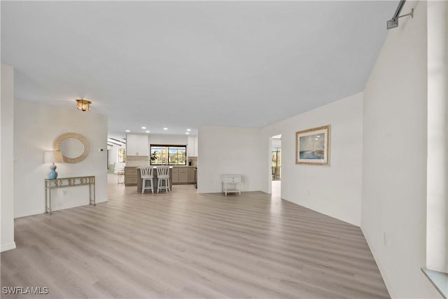 unfurnished living room with light hardwood / wood-style flooring