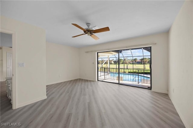 empty room featuring ceiling fan and light wood-type flooring