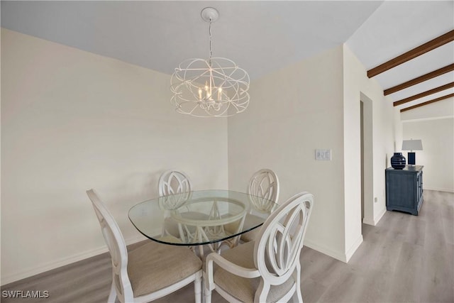 dining space featuring vaulted ceiling with beams, light hardwood / wood-style flooring, and a notable chandelier