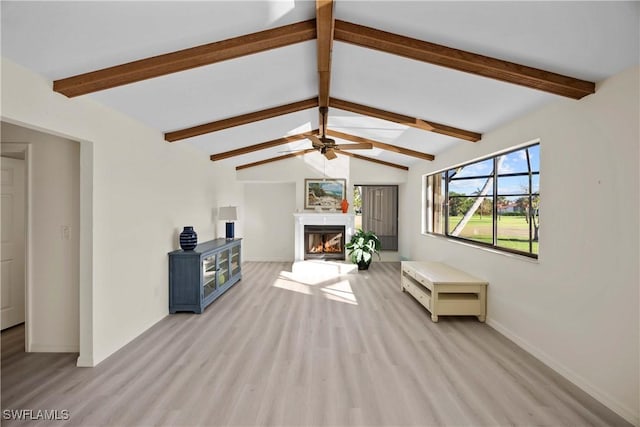 unfurnished living room with vaulted ceiling with beams, light hardwood / wood-style floors, and ceiling fan