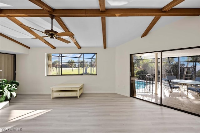 interior space featuring vaulted ceiling with beams, plenty of natural light, ceiling fan, and light hardwood / wood-style flooring