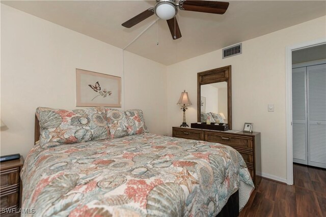 bedroom with a closet, dark hardwood / wood-style floors, and ceiling fan