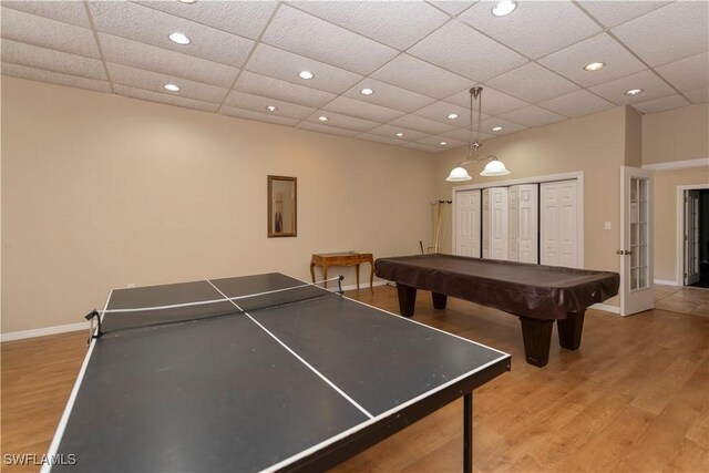 rec room featuring light wood-type flooring, a paneled ceiling, and pool table