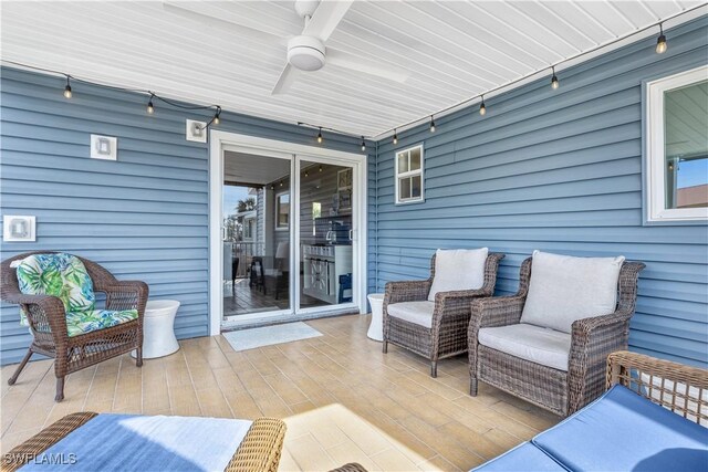 deck featuring ceiling fan and an outdoor living space