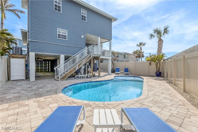 view of swimming pool featuring a patio area and central air condition unit