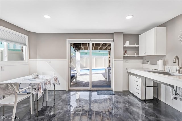 kitchen featuring sink and white cabinets