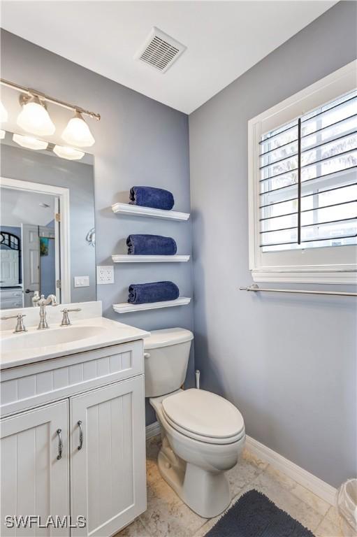 bathroom with tile patterned floors, vanity, and toilet