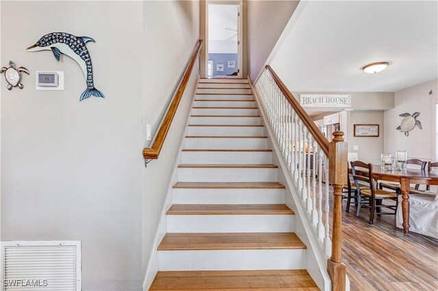 stairs featuring hardwood / wood-style flooring