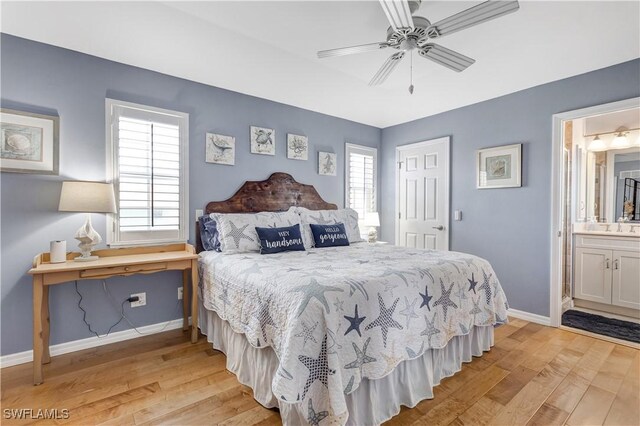 bedroom with sink, light wood-type flooring, ceiling fan, and connected bathroom