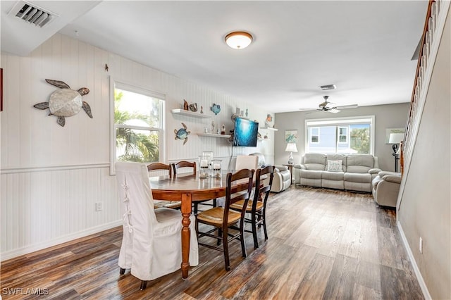 dining space with a healthy amount of sunlight, dark wood-type flooring, and ceiling fan