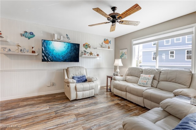 living room with wood-type flooring and ceiling fan