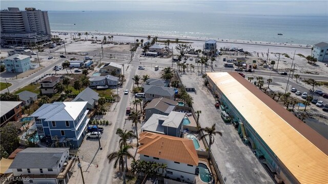 bird's eye view featuring a view of the beach and a water view