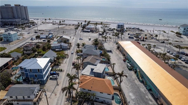 birds eye view of property with a water view and a view of the beach