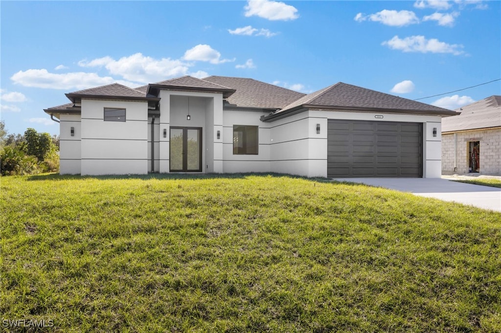 view of front of property with a garage and a front yard