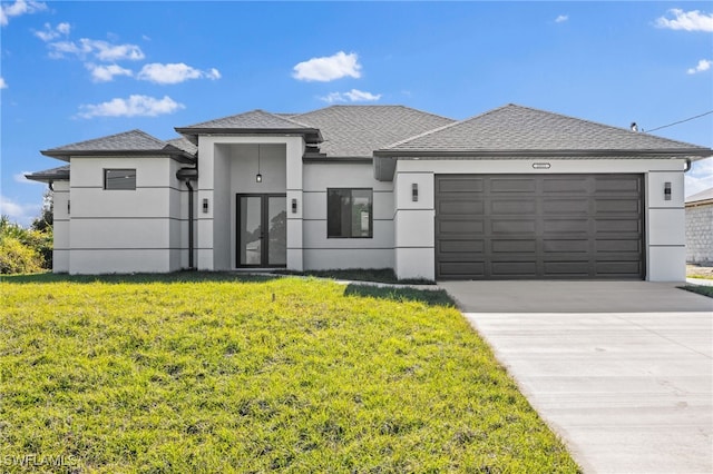 view of front facade with a front yard and a garage