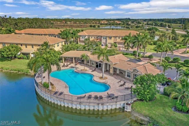 view of swimming pool with a water view and a patio area